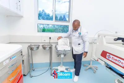 Doctor operating diagnostic equipment in a Siloam Hospital exam room