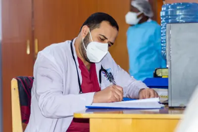 Doctor reviewing patient notes at a desk in Siloam Hospital